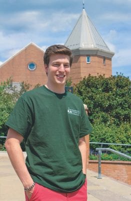 student standing at the top of the circle stairs