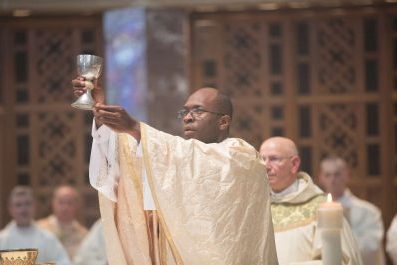 Priest Lifting the chalice